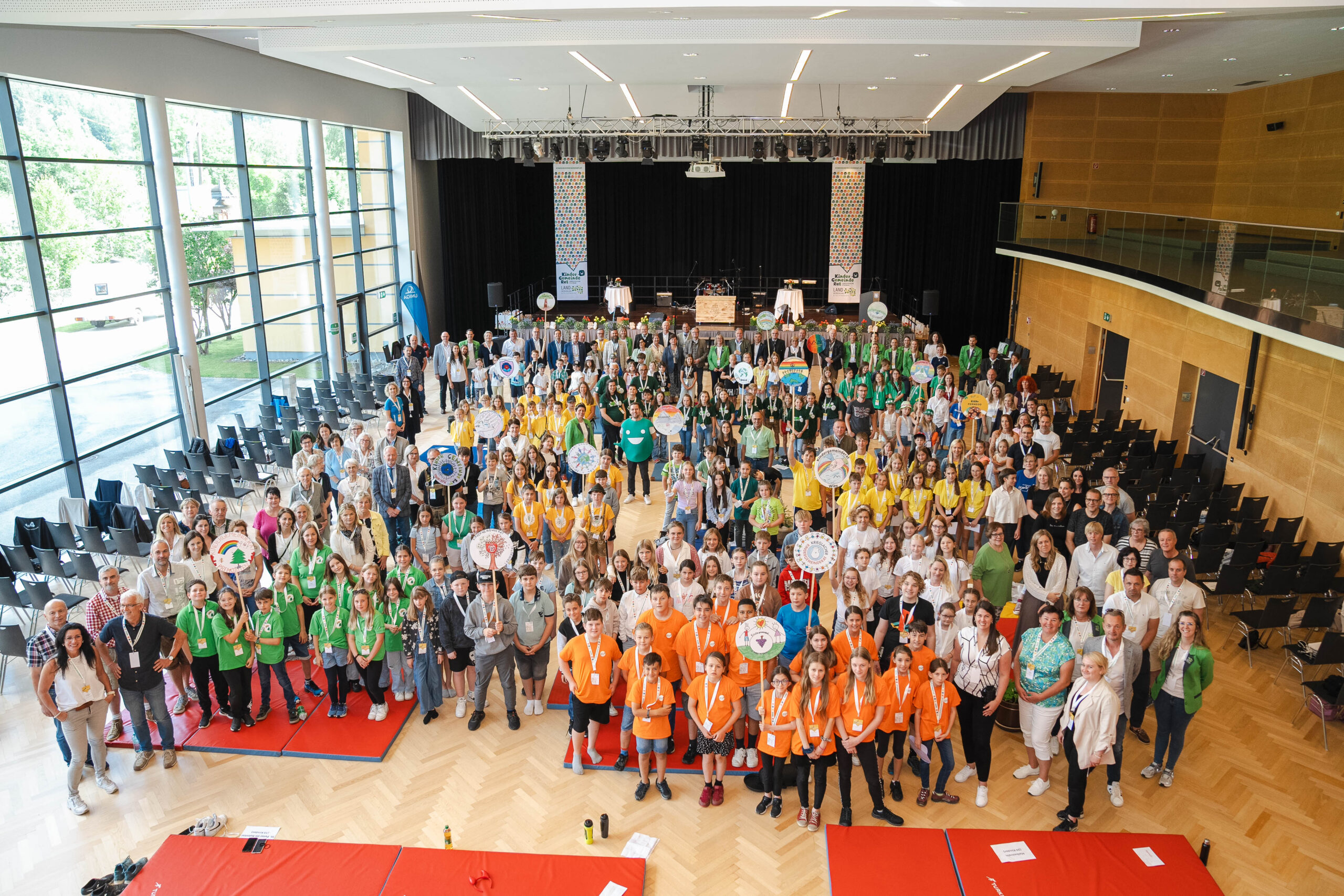 Viele Kinder stehen in einer großen Turnhalle nebeneinander